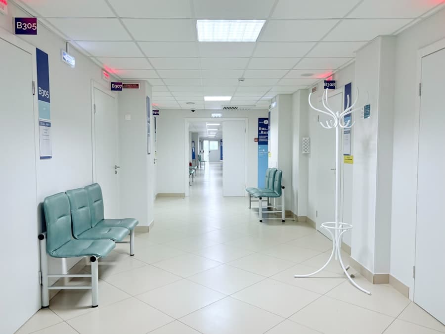 Empty hospital corridor with benches and doors. Stock photograph, not taken at any listed clinic.