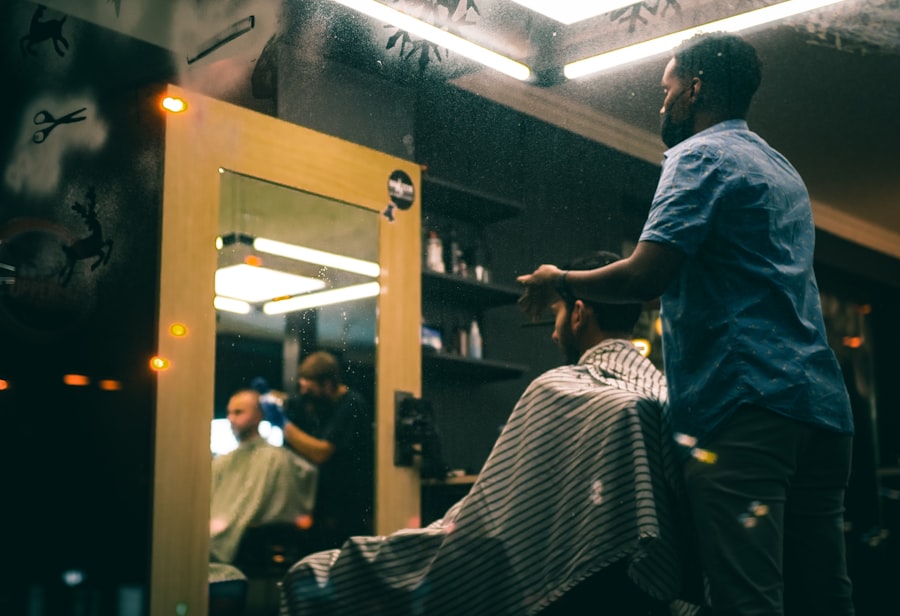 Man in gray t-shirt standing in front of mirror. Stock photograph, not taken at any listed clinic.