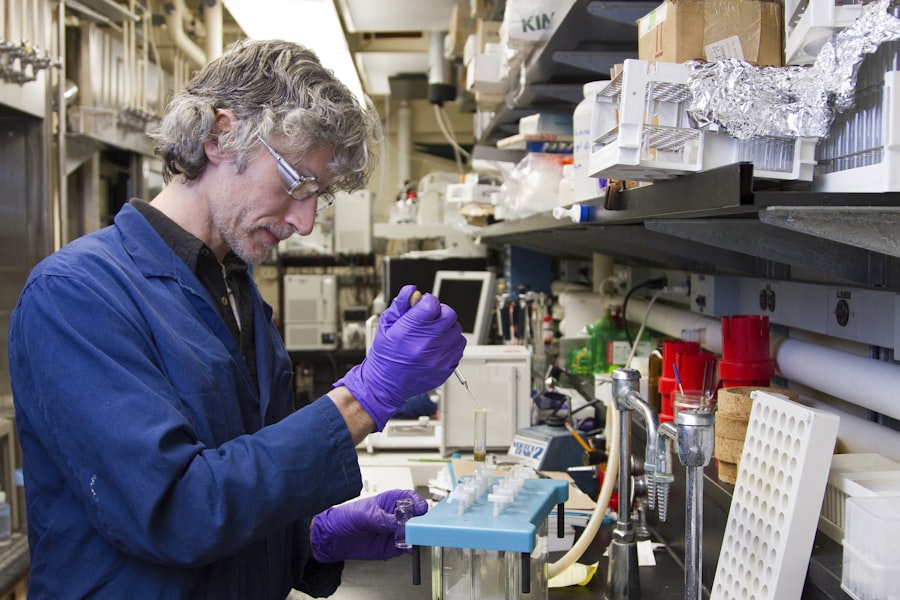 Woman dropping a specimen on a test tube. Stock photograph, not taken at any listed clinic.